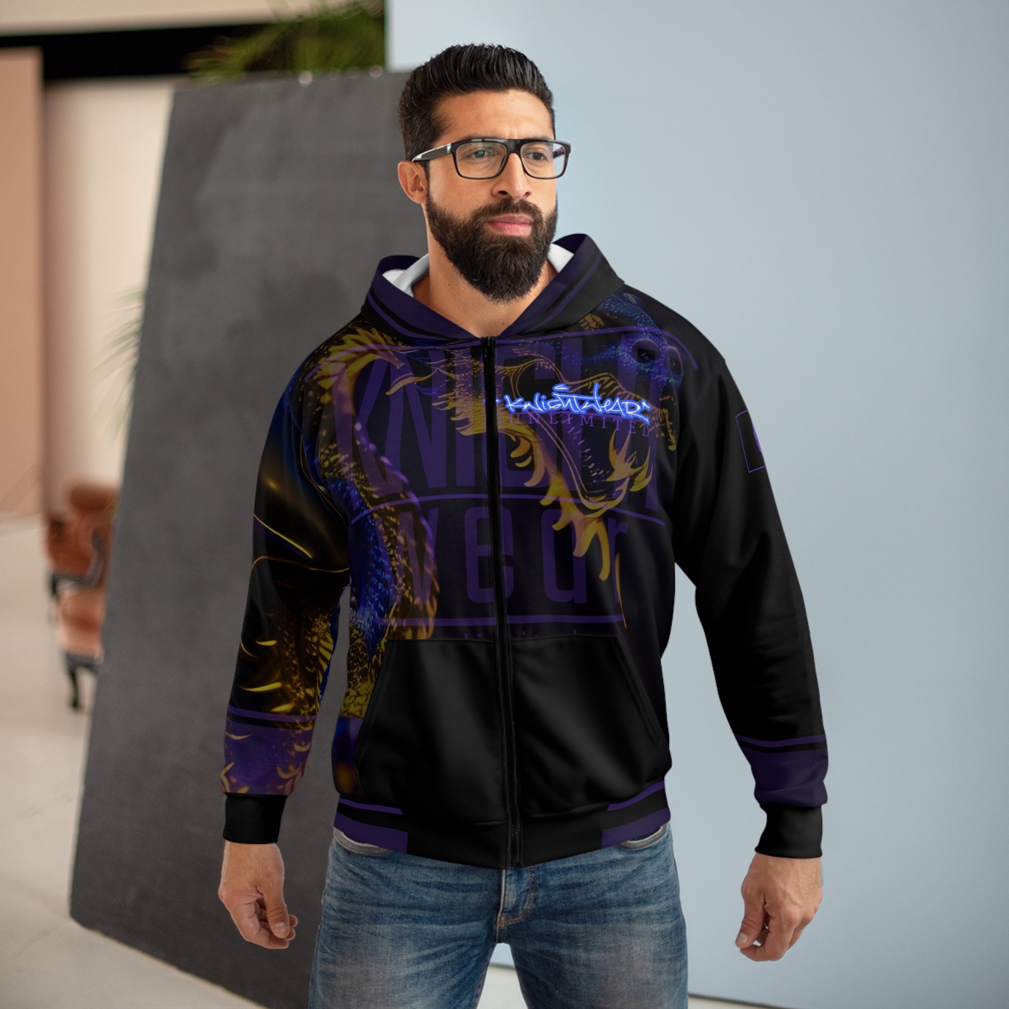 Man wearing a KnightWear black hoodie with colorful designs and text, standing outdoors.